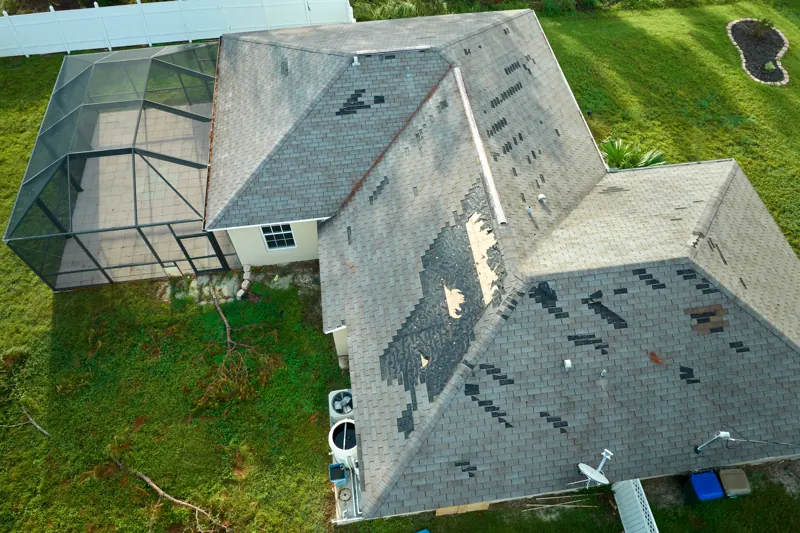Aerial view of a house roof showing missing shingles